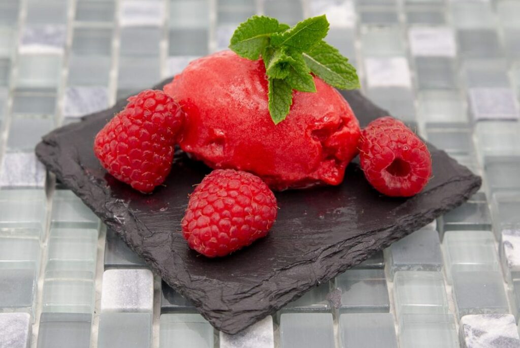 A delicious creamy raspberry sorbet decorated with mint.
