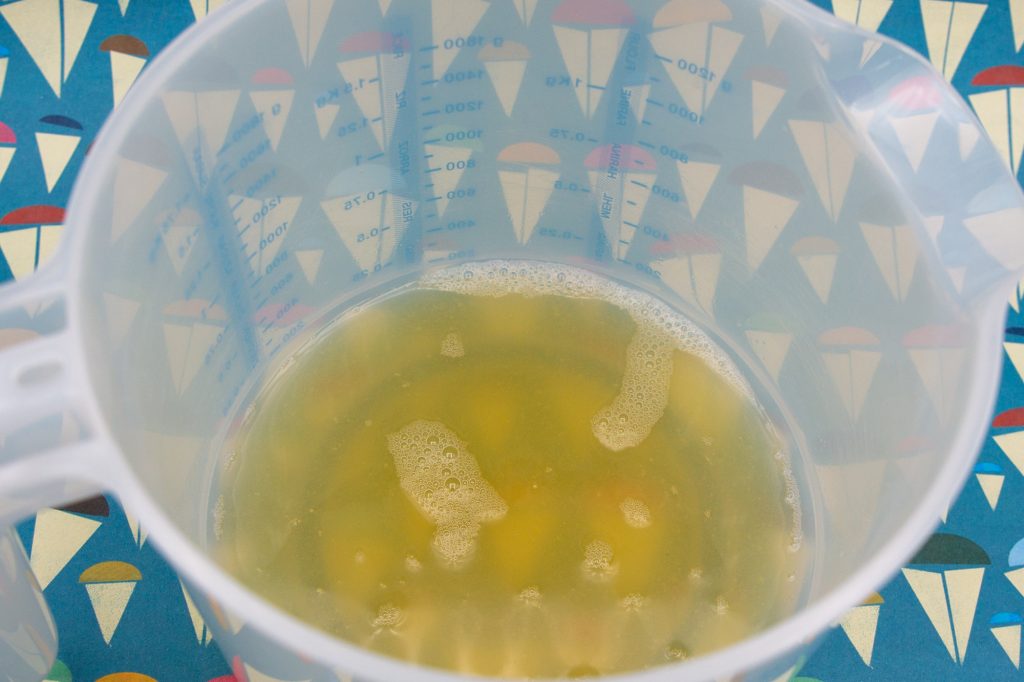 Pour the collected drained water into a fat-free mixing bowl