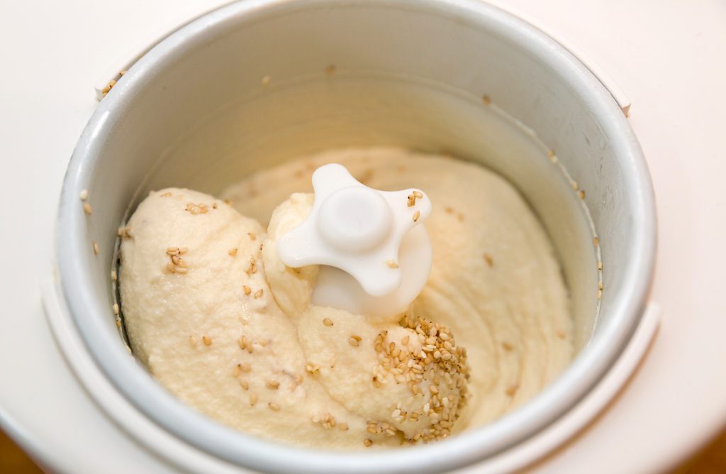 Creamy sesame honey ice cream during production in the ice cream machine