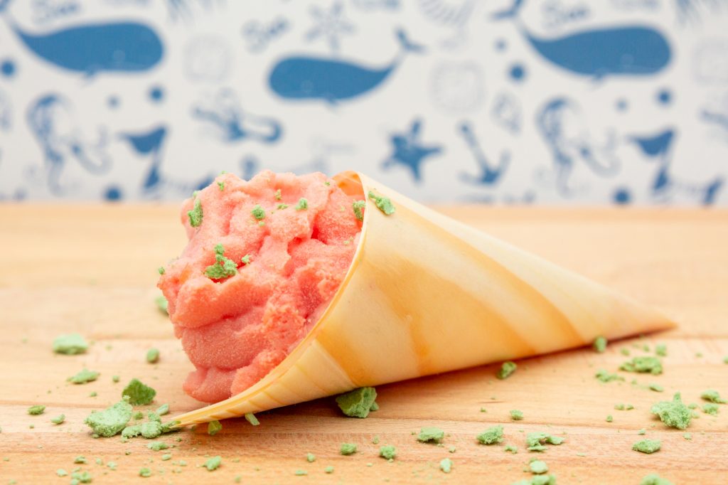 Watermelon ice cream with buttermilk in wooden croissants with green meringue