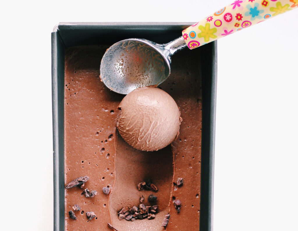 A scoop helps to form beautiful ice cream scoops