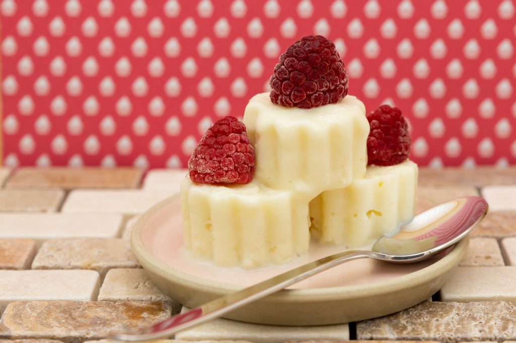 Vegan frozen yoghurt ice cream with organic raspberries - out of the freezer due to the season