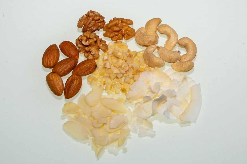 Nuts, almonds or coconut flakes make a very good topping on frozen yoghurt and are definitely vegan