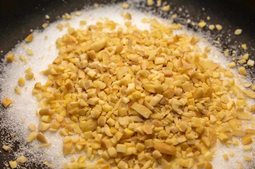 At the beginning, add the sugar and the chopped nuts or kernels together in the pan
