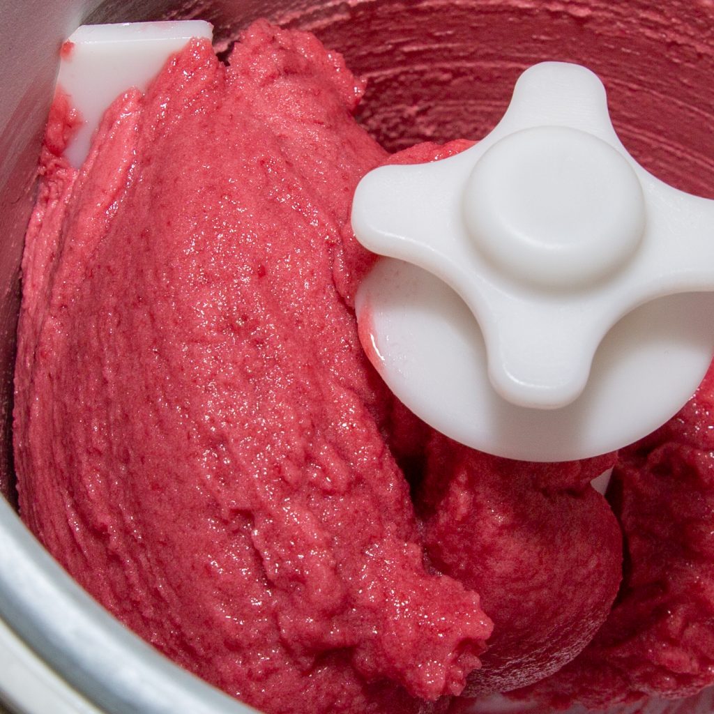 Cherry ice cream in the ice cream machine shortly before completion.