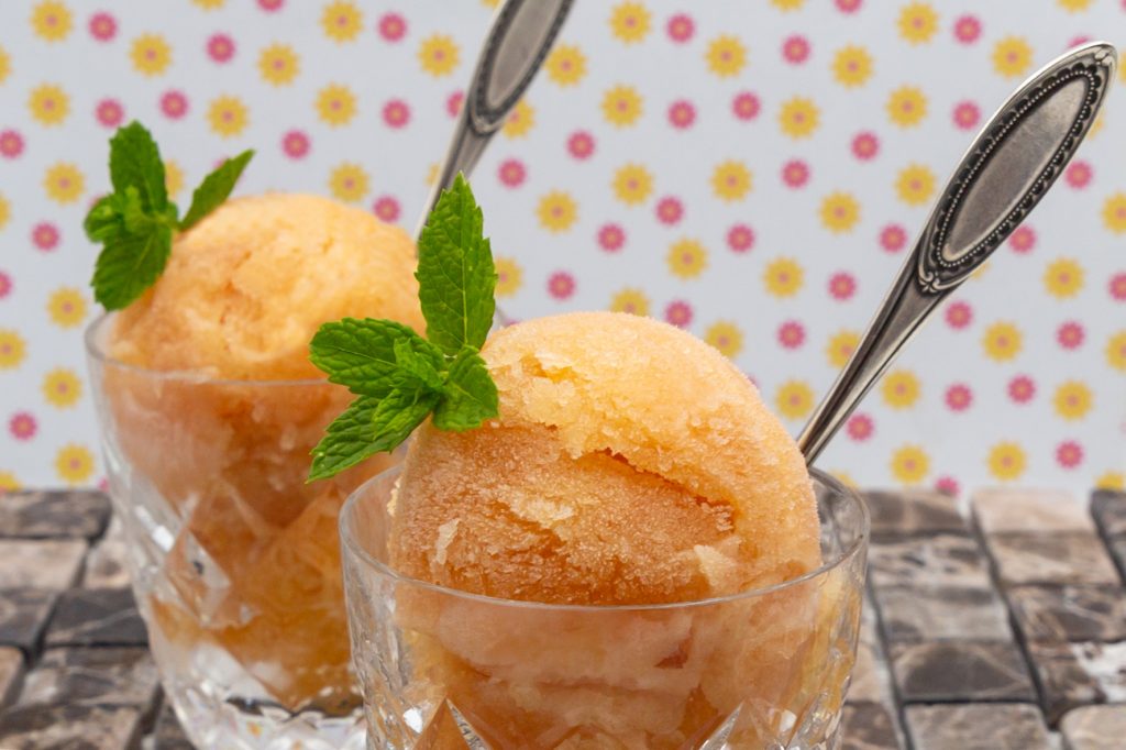 Refreshing grapefruit sorbet decorated with mint leaves.