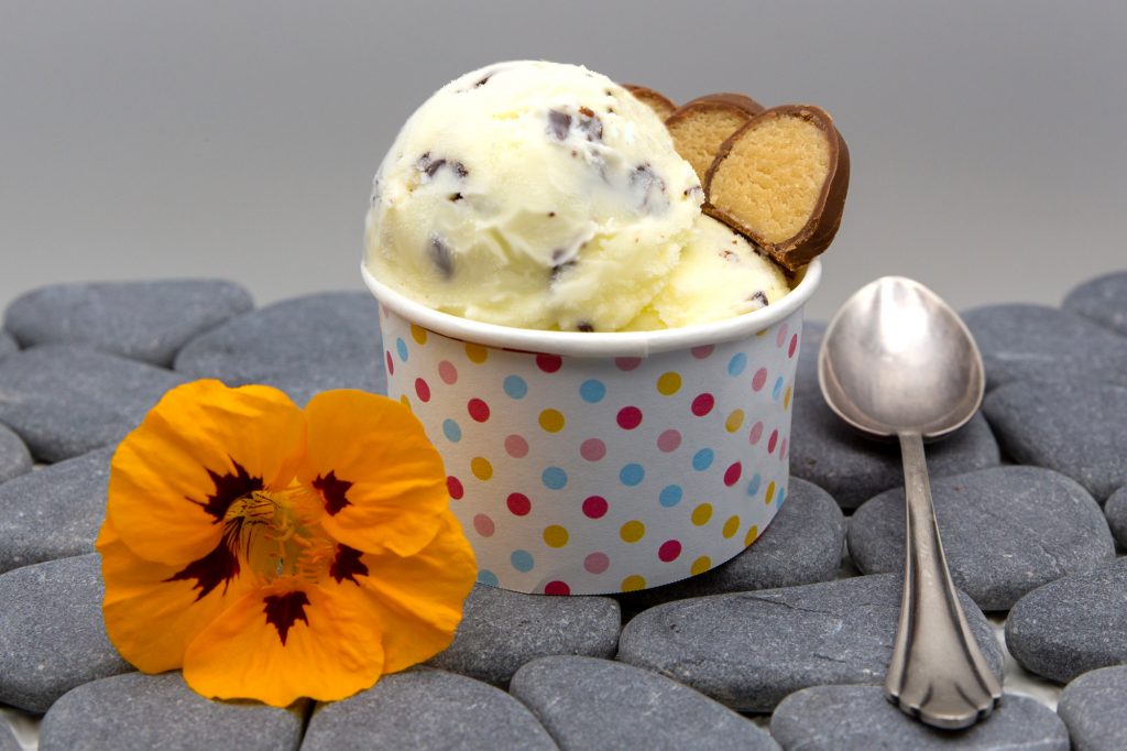 Marzipan ice cream with chocolate shavings and decorated with marzipan slices.