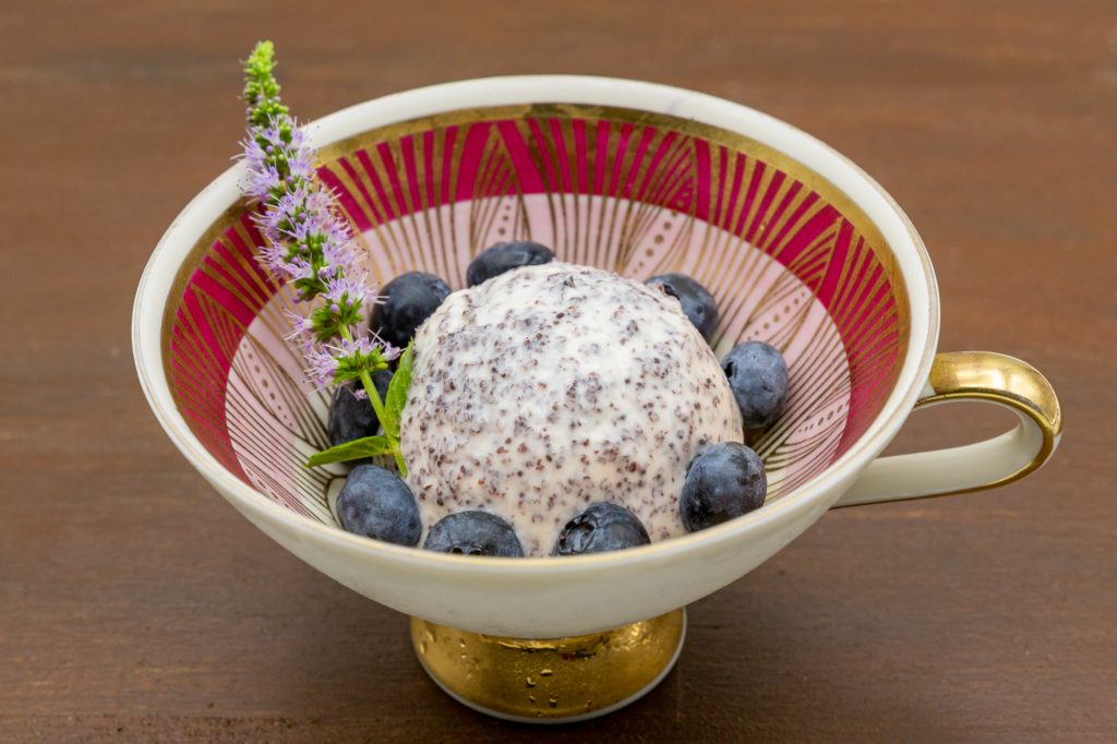 Poppy seed ice cream is an eye catcher for every dessert course. Here decorated with a mint blossom.