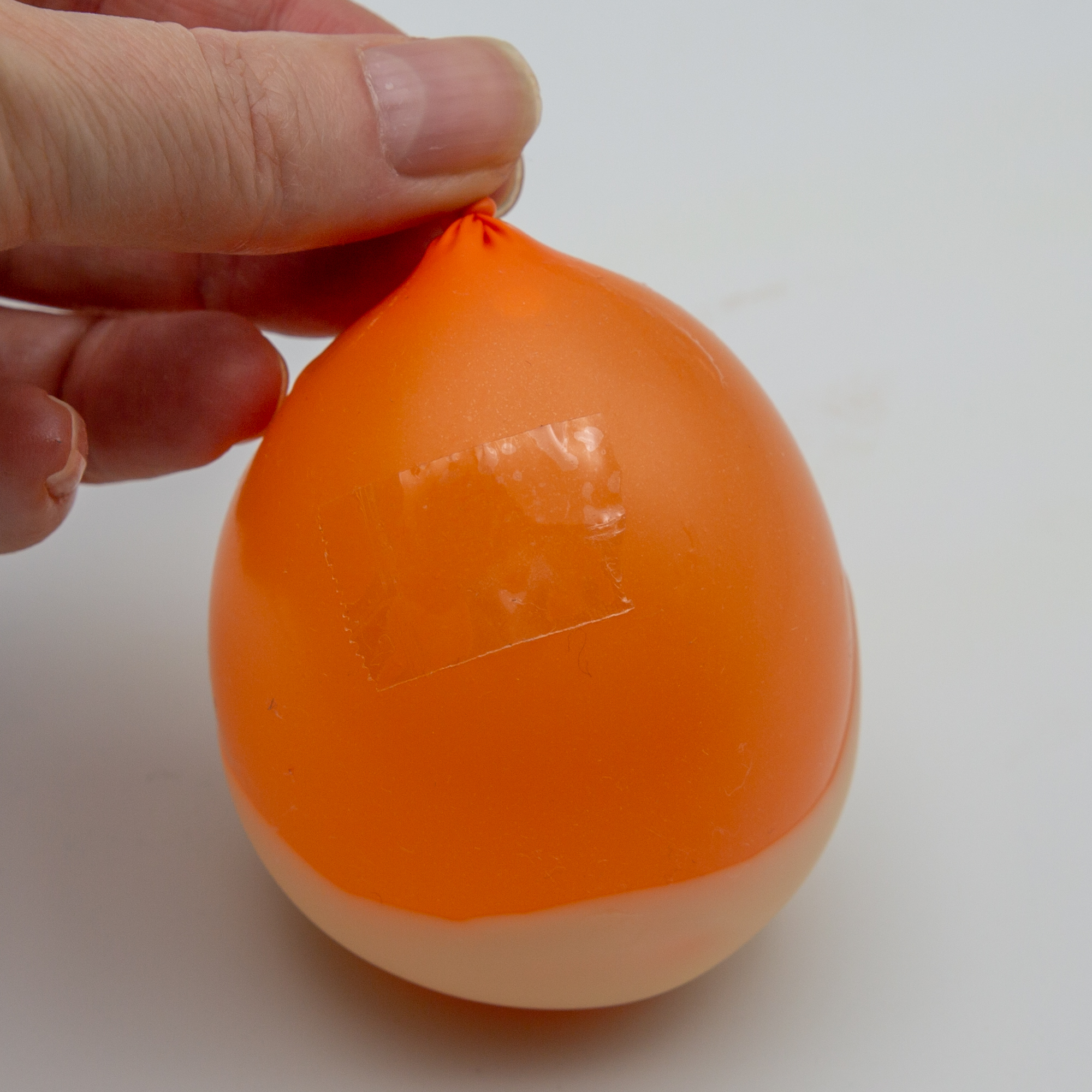 Dip the balloons into the chocolate and when the chocolate is firm, stick a piece of sticky tape onto an uncovered surface.