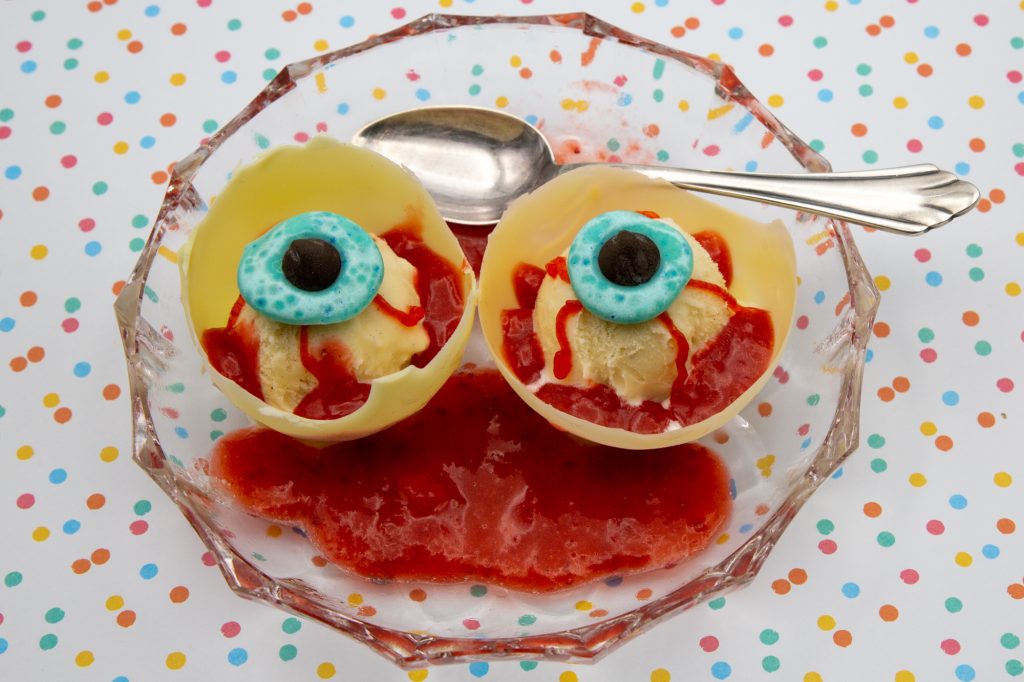 The finished creepy eyeballs made from vanilla ice cream and strawberry sauce.