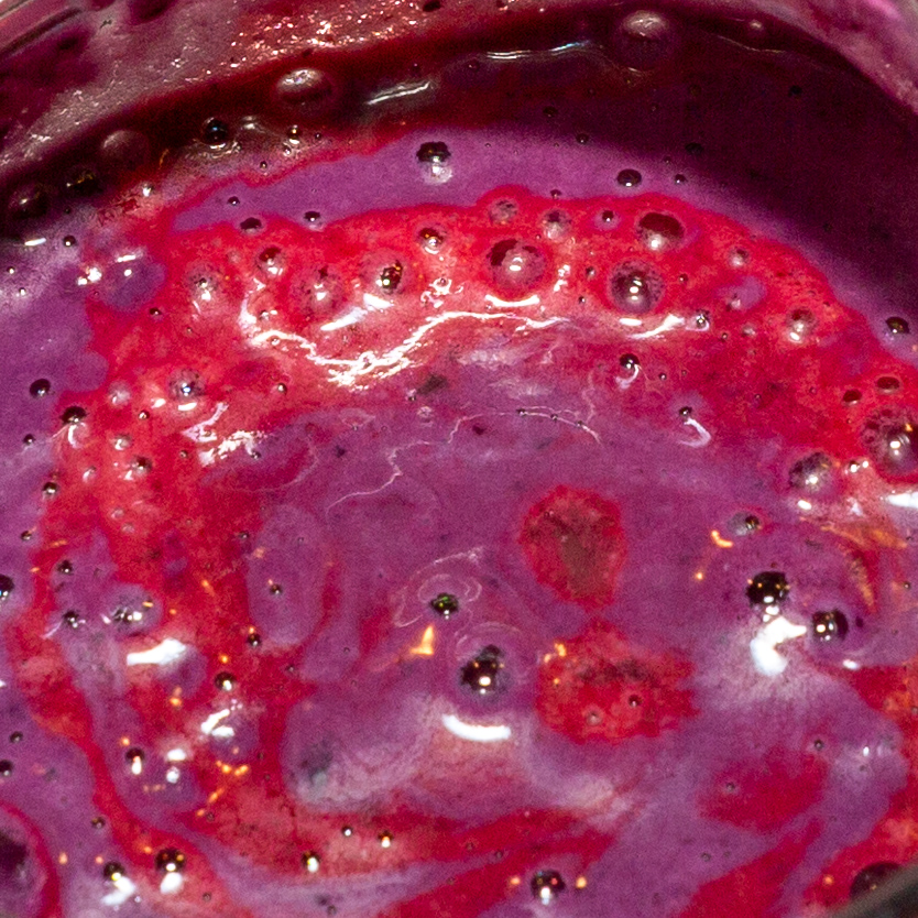 The lemon juice changes the color of the blueberry ice cream mixture from dark purple to a lighter shade.