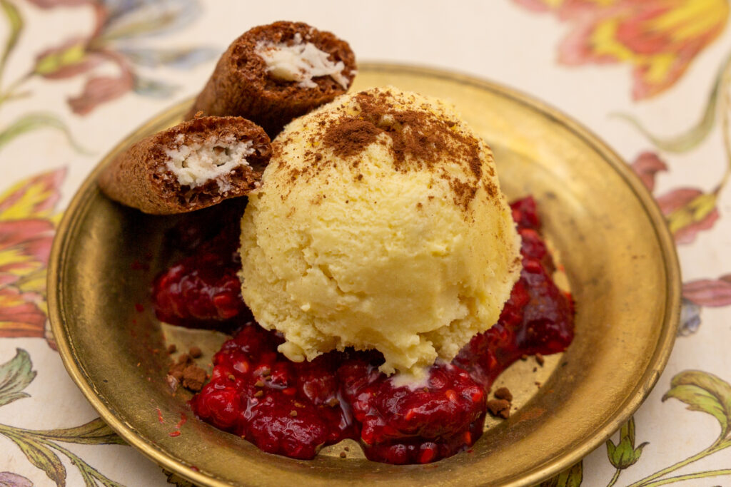Passion fruit ice cream on raspberry sauce and dusted with cocoa.