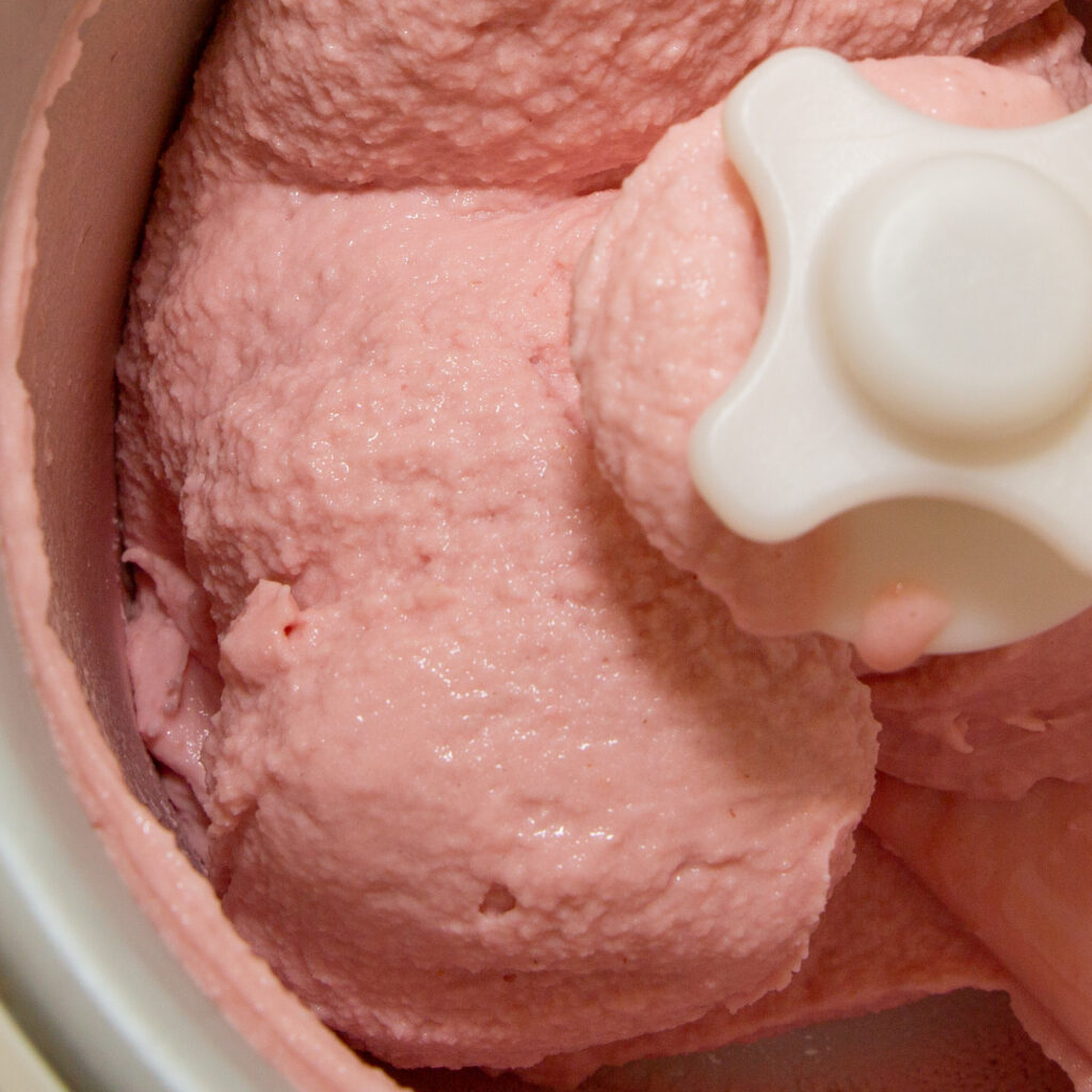 Ready raspberry ice cream in the ice cream maker.