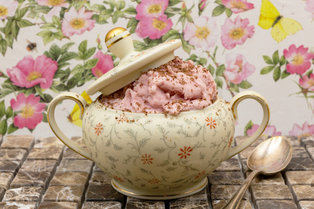 Raspberry ice cream with fine chocolate shavings served in an old sugar bowl.