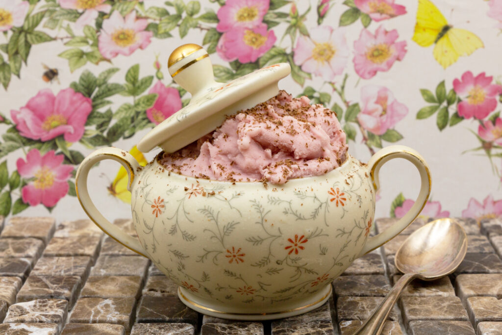 Raspberry ice cream Raspberry ice cream with fine chocolate shavings served in an old sugar bowl.