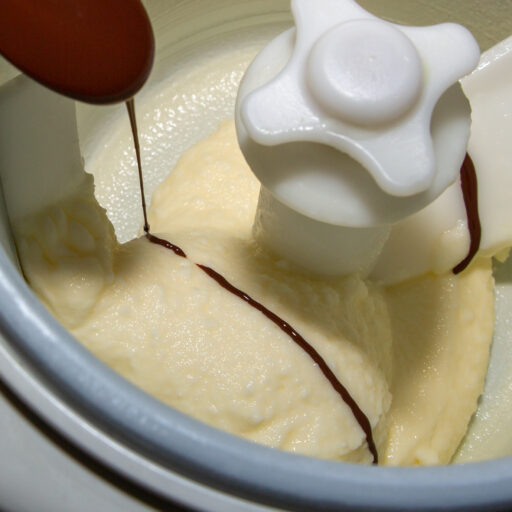 The melted chocolate is dripped into the marzipan ice cream while the ice cream machine is running.