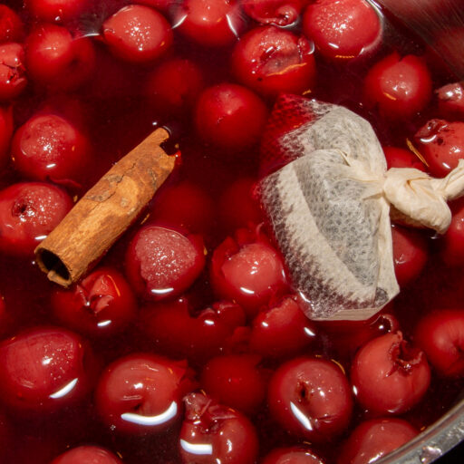 Hot cherries are cooked with cinnamon stick and peppercorns.
